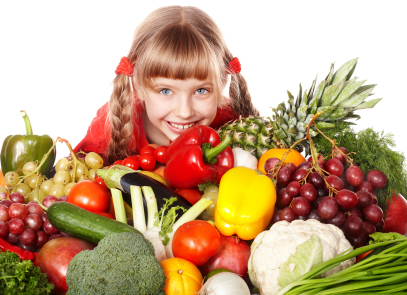girl with mound of raw fruit and veggies